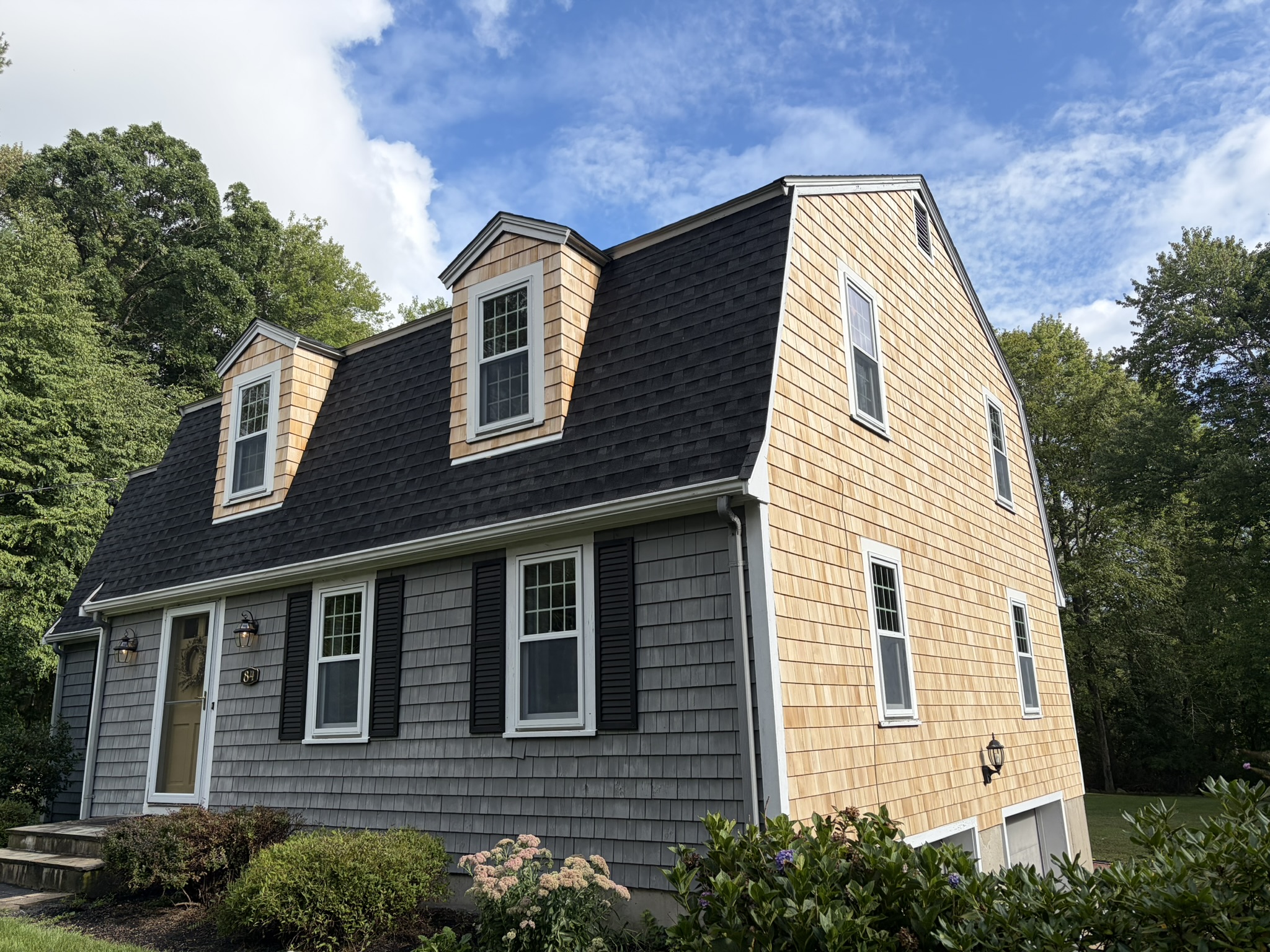 Finished gambrel-roof home with new shingles and siding by Red Sky Construction, Greater Boston